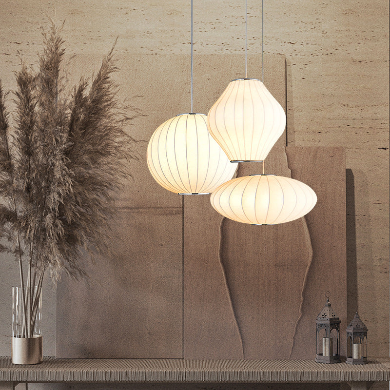 Three hanging lights on a wooden surface with a textured wall background